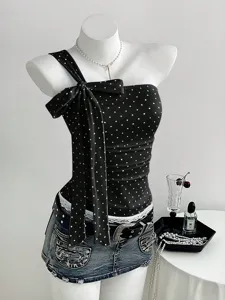 Detail view of the black and white polka dot one shoulder bow strap top with stylish design.
