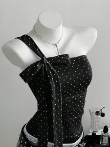 Black and white polka dot one shoulder camisole with stylish bow detail and stretch fit.