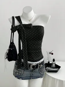 Close up details of the chic black polka dot one shoulder bow strap women camisole top.