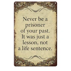 Vintage inspirational quote wall sign detail, rustic motivational metal plaque decor.