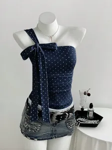 Elegant navy blue polka dot off-shoulder camisole featuring a large statement bow, stylish and chic.