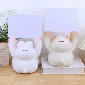 Detailed view of cute animal piggy banks with message boards and coin slots on a neat desk.