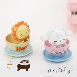 Cute animal figures inside small teacups detail shot, desktop decoration and car ornaments.