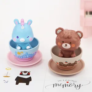 Close-up detail of cute animal bobblehead figures in small cups, perfect for car decor.