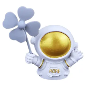 Cute astronaut car air freshener vent clip with golden visor and clover, aesthetic auto decor.