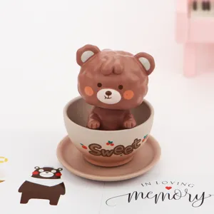 Cute cartoon bear cup ornament detail view, lovely resin bobblehead for desk decor.