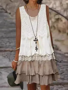 Women fashion lace patchwork sleeveless tiered dress detail view showing layered design.