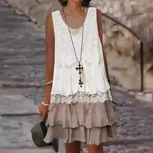 Detail view of the elegant lace patchwork sleeveless midi dress with ruffled hem.