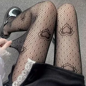 Black heart-patterned fishnet tights with lace detail, showing high elasticity and trendy style.