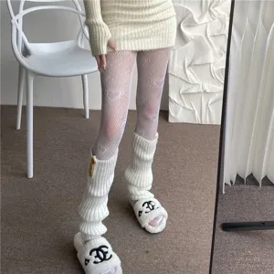 Detailed view of white heart pattern fishnet tights for women, hollow lace hosiery for stylish outfits.