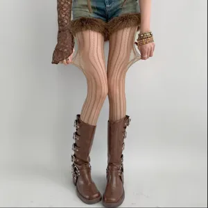 Close-up detail shot of women vertical striped tights hosiery worn with fashion boots.
