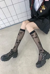 Close-up detail shot of sheer black mid-calf socks for women, breathable summer hosiery style.