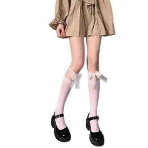 Japanese JK style white knee-high socks with cute bowknot and black platform shoes.