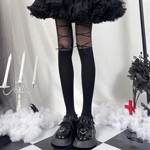 Black gothic lace-up bow pantyhose detail, sheer strap tights close-up display style.