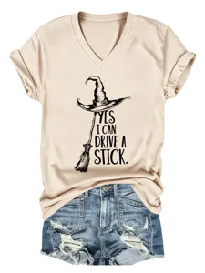 Detail view of a beige V-neck short sleeve t-shirt featuring a witch hat graphic and text print.