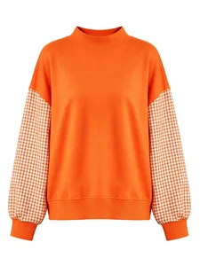Orange sweatshirt detail featuring contrast gingham puff sleeves, mock neck and ribbed hem.