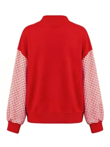Detail view of red long sleeve sweatshirt featuring contrasting gingham checkered sleeves.