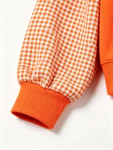Orange gingham sleeve detail women sweatshirt close up fabric texture knit cuff comfortable wear