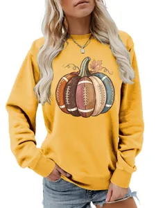 Close-up detail of women autumn sweatshirt featuring unique football pumpkin graphic print.