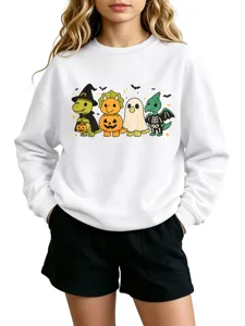 Close-up detail of the cute Halloween dinosaur graphic print on the white sweatshirt.