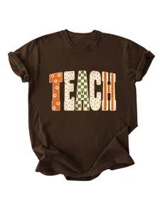 Detailed close-up of brown short sleeve t-shirt with retro TEACH typography print.