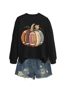 Detailed view of the black sweatshirt featuring a unique football pumpkin graphic print.