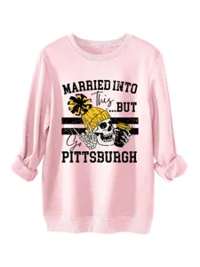 Casual pink crewneck sweatshirt featuring a graphic skull print and bold slogan design.