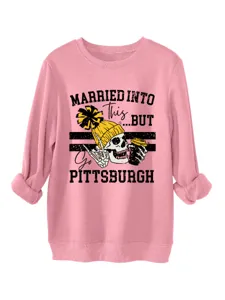 Close-up detail of pink long sleeve graphic sweatshirt featuring funny skull print.