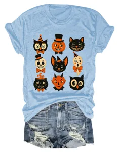 Close-up detail showing the retro Halloween print with cute funny characters on the light blue tee.