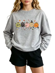 Close-up detail of the cute autumn pumpkin graphic on the grey long sleeve crewneck sweatshirt.
