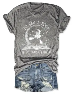 Close-up detail of grey distressed short sleeve t-shirt featuring witch graphic print.