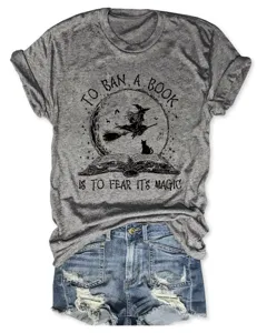 Grey vintage short sleeve t-shirt with book and witch graphic, paired with ripped denim shorts.