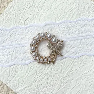 Detailed view of the elegant pearl butterfly rhinestone brooch and gemstone base tray accessory.