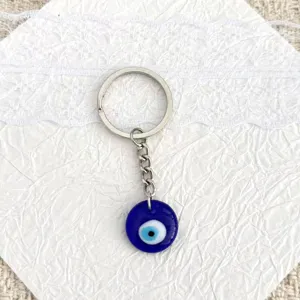 Detailed close-up shot of a Turkish evil eye blue glass keychain charm pendant accessory.