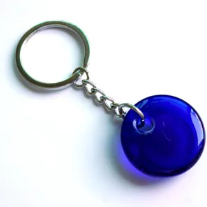Close-up detail of the blue glass evil eye keychain pendant featuring polished metal rings.