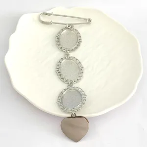 Detail view of retro stainless steel brooch blank with lace oval trays and heart pendant.