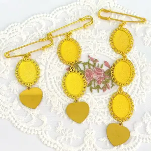 Close-up detail of retro gold brooch pin bases featuring oval trays and heart metal pendants.