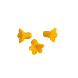 Detail view of bright yellow morning glory flower shaped loose beads for jewelry DIY.