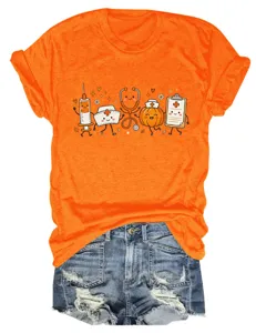 Close-up of orange short sleeve tee featuring cute medical cartoon graphics and denim shorts.