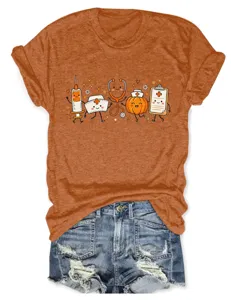Close-up of the cute Halloween medical graphic print featuring syringe, pumpkin and cute nurse hat.