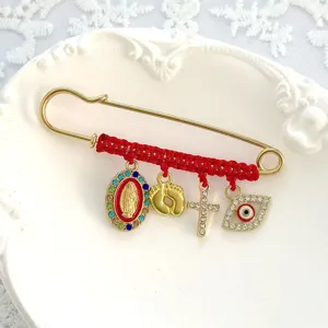 Red string braided rhinestone brooch vintage alloy safety pin with evil eye and cross charms for fashion.