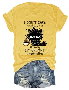 Close-up detail of the funny cat graphic print and soft yellow fabric on the casual short sleeve.