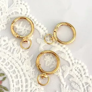 Gold round spring snap hooks close-up view, durable alloy keychain hardware for DIY crafts.