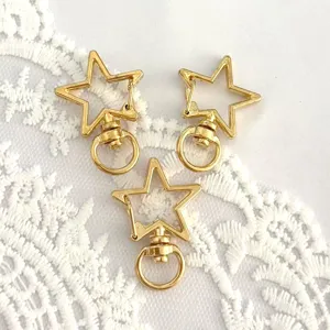 Gold star swivel snap hook detail, metal alloy lobster clasp for DIY jewelry making.
