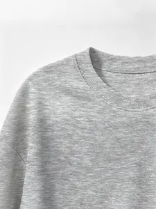 Close up detail of kids grey crewneck sweatshirt with soft rib knit fabric for children apparel