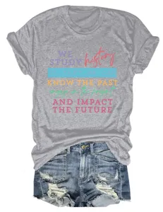 Grey graphic t-shirt paired with distressed denim shorts, casual women's summer outfit.