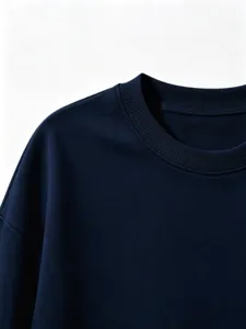 Close-up detail of dark blue children sweatshirt, ribbed crewneck knit collar, solid texture.
