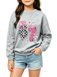 Close-up detail of gray kids sweatshirt featuring number graphic print and cute pink bow accents.