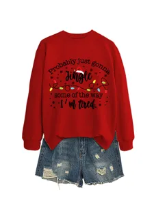 Detailed view of the red holiday graphic sweatshirt paired with distressed denim shorts.