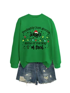 Women's green Christmas graphic sweatshirt paired with denim shorts, casual holiday pullover top.